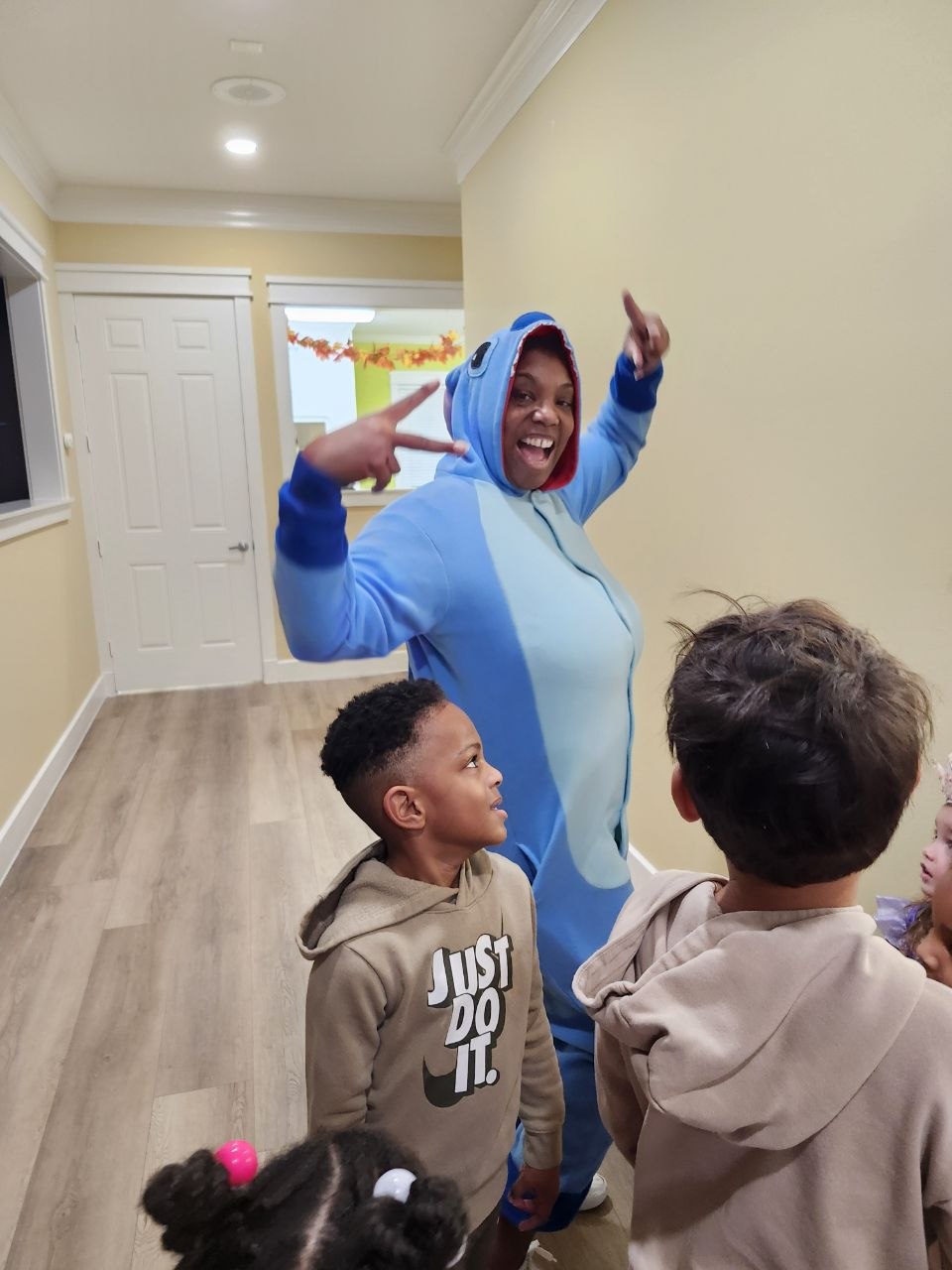 A smiling teacher wearing a Stitch costume, from Lilo and Stitch.
