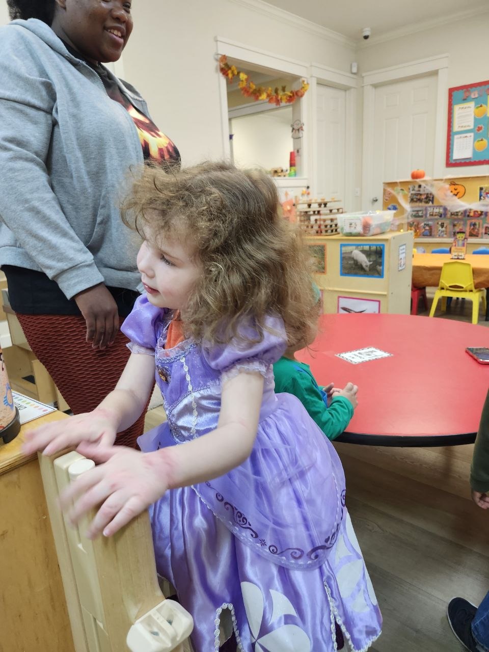 A girl in a purple princess outfit.