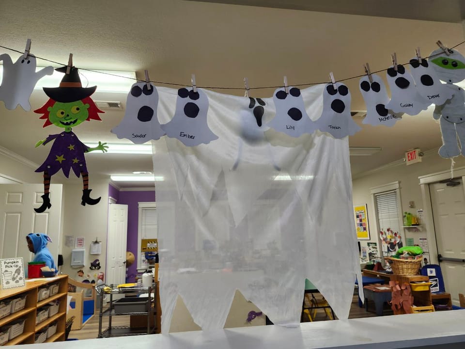 A daycare room with a bunch of ghosts, a witch, and a mummy decorations.